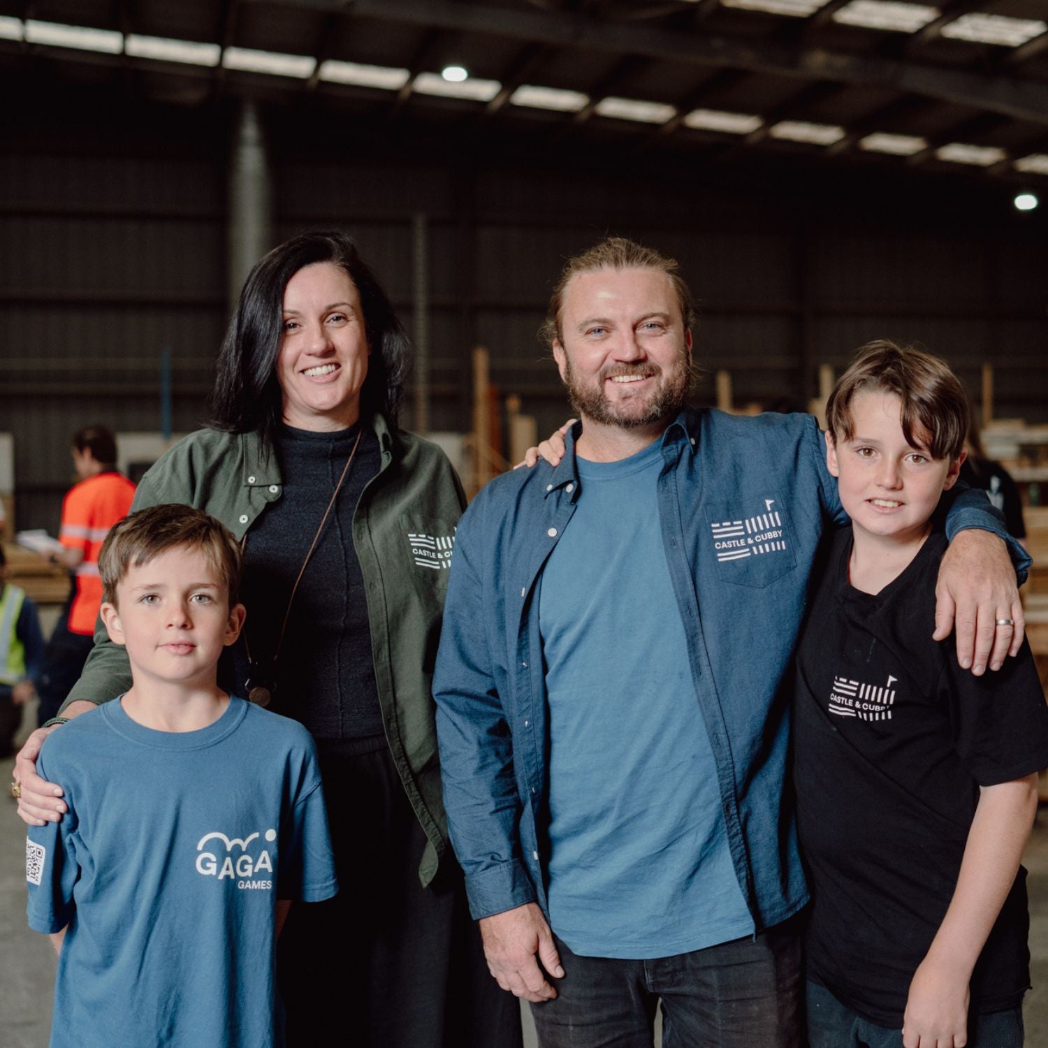 The family owners of Gaga Games and Castle & Cubby, featuring Mum and Dad with their two boys aged 12 and 10, all dressed in branded company clothing, smiling for the camera.