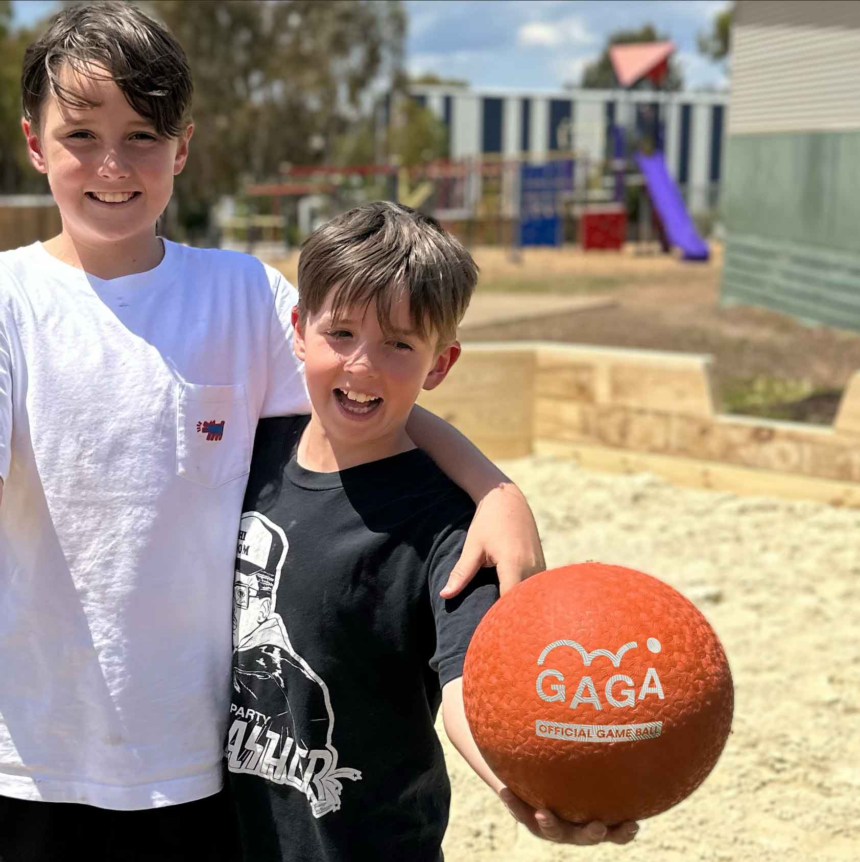 Kids playing with Gaga ball in school Gaga pit playground