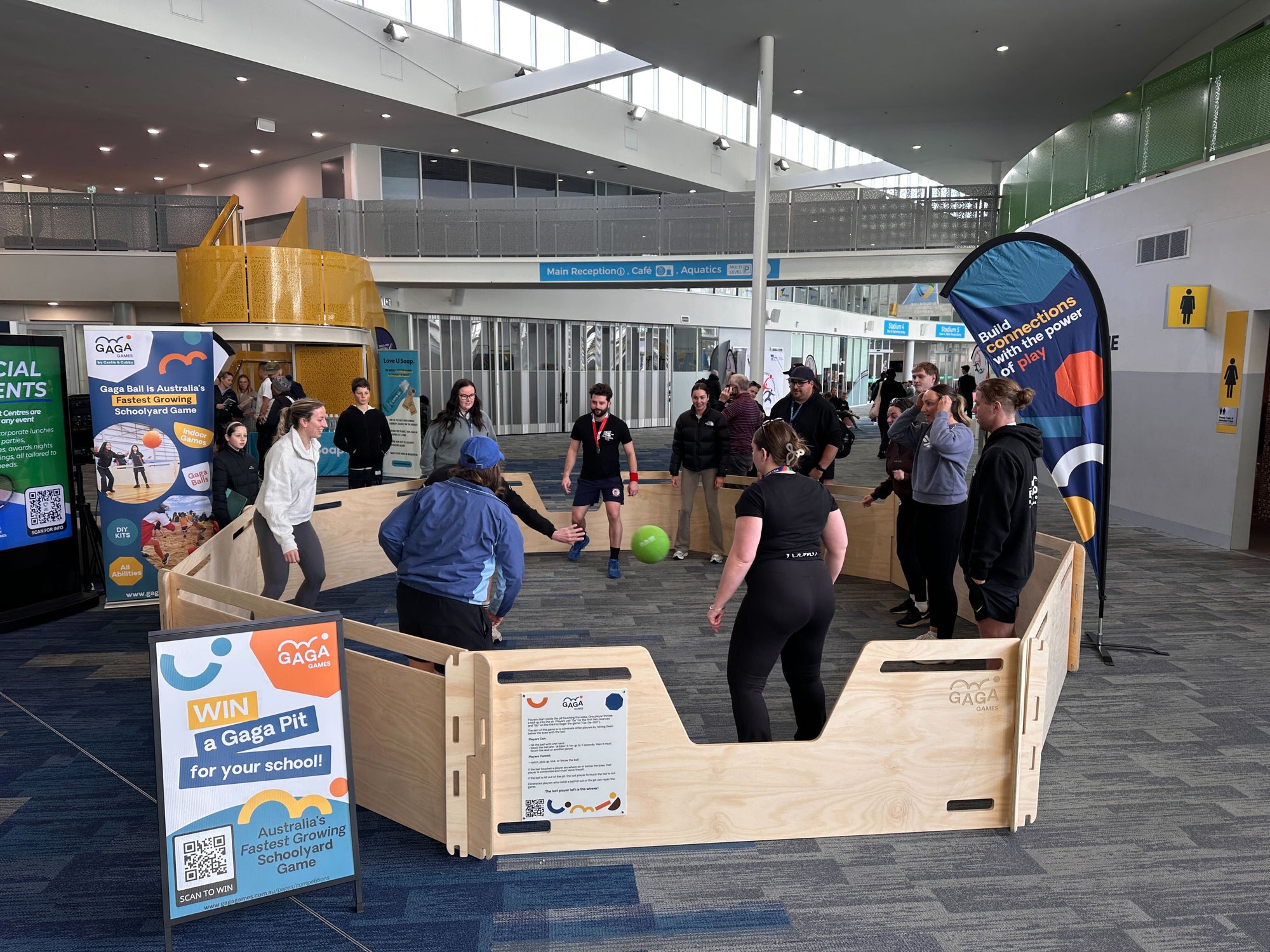 A gaga ball pit with teachers playing gaga ball inside at the victorian teacher games central hub