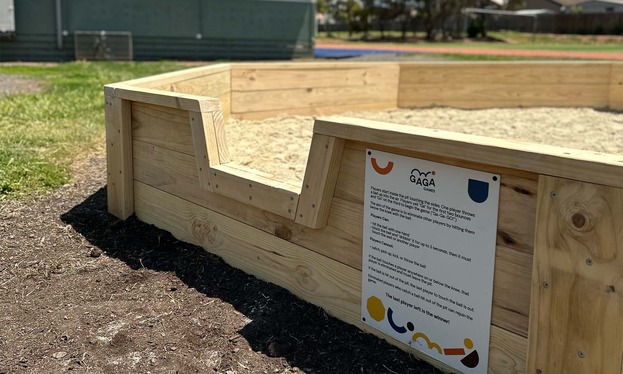 Close up of Timber Outdoor Gaga Ball Pit entry and sign by Gaga Games Australia